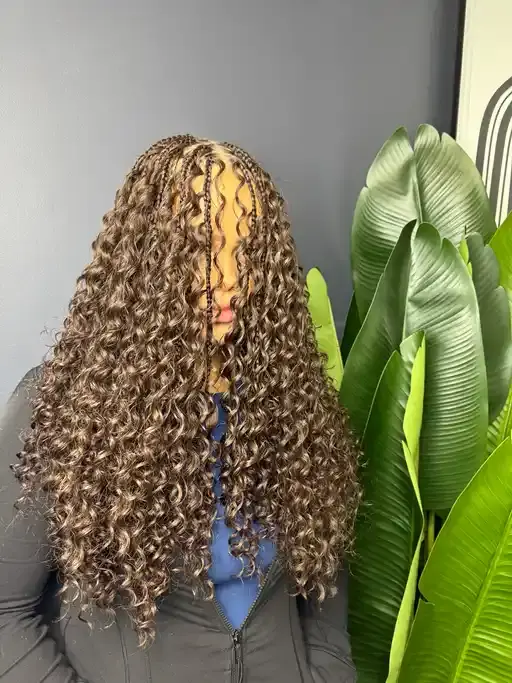 Boho box braids with loose curls throughout.